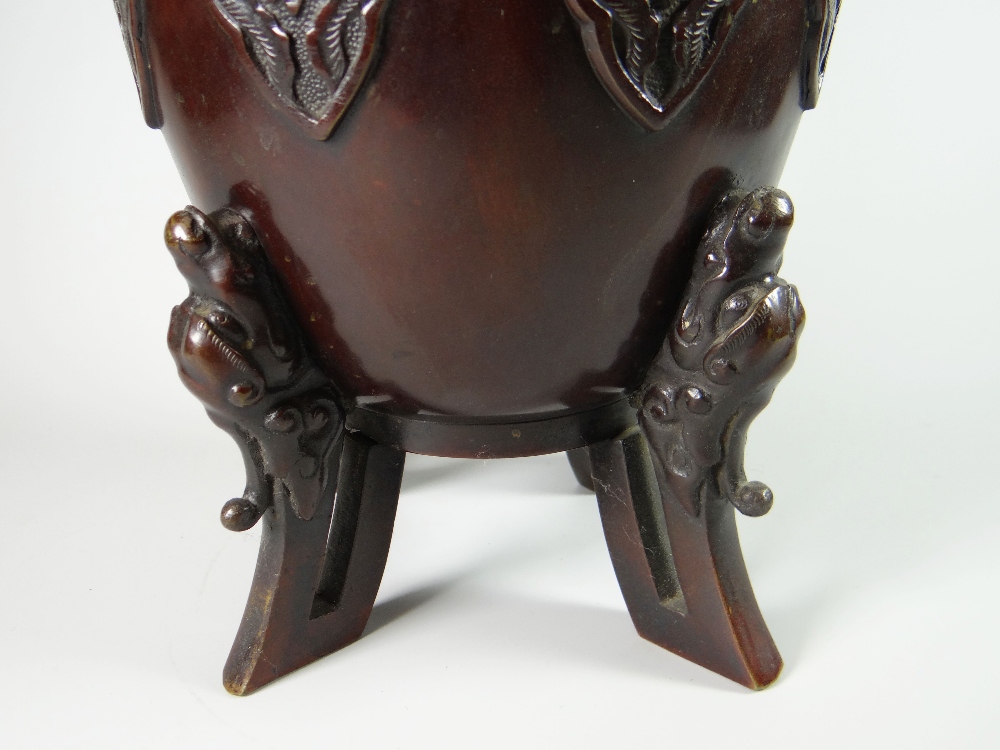 A tall bronze Chinese temple vase of ovoid form on four dragon feet and with beast-mask terminals to - Image 3 of 3