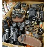 A large collection of mixed vintage binoculars including some military examples noted, varying