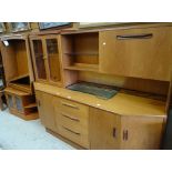 A mid-century G-Plan lounge unit with glazed top and cupboard and drawers to the base together