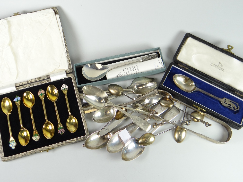 A parcel of silver spoons including a cased set of six silver gilt spoons with floral enamel