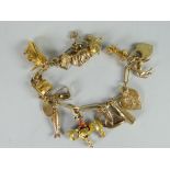 A 9ct yellow gold bracelet with collection of charms being mainly 9ct yellow gold (purchaser