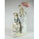 A large Lladro pottery model of two ladies - one seated with puppy, the other standing with parasol,