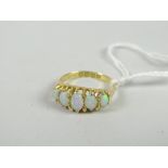 An 18ct yellow gold antique ring set with five graduated oval opals Condition reports provided on