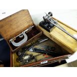 A vintage vanity case containing vintage engineering tools including callipers, lathe mount (take