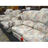 Modern fabric upholstered floral decorated three-piece suite comprising two-seater settee and two
