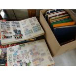 A cardboard container containing 14 stock albums of stamps Condition reports provided on request