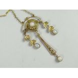 A believed 9ct yellow gold antique pendant set with opals and seed pearls on a fine chain