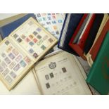 A brown cardboard carton containing numerous stamp albums including small Rowland Hill blue album