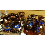 A collection of nineteen copper lustre jugs and a copper lustre cup Condition reports provided on