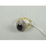 An 18ct yellow gold set diamond chip and centred sapphire oval ring Condition reports provided on