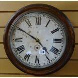 An Ansonia American circular dial station-office type wall clock in oak surround and bearing Roman