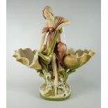 A Royal Dux pottery model of a maiden catching a fish in a net, flanked by two open clam shells over