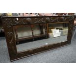 Manner of John Pearson Arts & Crafts copper and wood rectangular wall mirror decorated with bird,