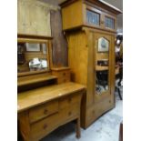 An Arts & Crafts oak wardrobe, 204cms high x 105cms wide and matching dressing table, 99cms wide,