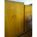 Pair of matching mid-century lightwood wardrobes, the ladies wardrobe with compartmented interior