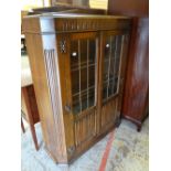 A good standing linen-fold and glazed bookcase with railback, 92cms wide (one pane of glass damaged)