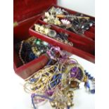 A vintage red jewellery box with mainly costume jewellery contents Condition reports provided on