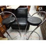 A set of four chrome and leather circular seated bar stools and a modern black leather armchair