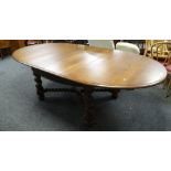 Twentieth century oak extending D-ended dining table having two lift out additional leaves, fretwork