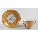 An early nineteenth century Coalport cup & saucer painted with studies of shells to each component