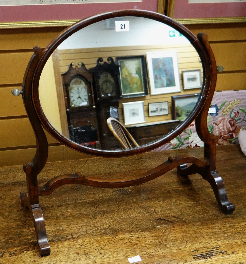 An early twentieth century mahogany oval toilet mirror on stand Condition reports provided on