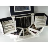 A cream wood concertina jewellery box and contents including silver dress rings, necklaces ETC