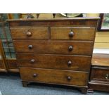 A Victorian chest of three long and two short drawers with marquetry detail and turned handles,