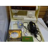 Plastic cased Singer 5525 sewing machine with foot pedal and accessories and a folding wooden