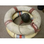 Two vintage life buoys and a plastic nautilus line float