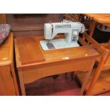 Jones sewing machine in a wooden work table