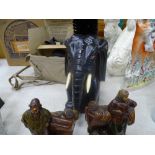 Pair of glazed terracotta Continental figures and a carved elephant brush holder