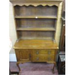 Small oak Welsh dresser having two upper shelves over two base drawers with a single side cupboard