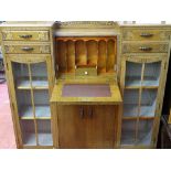 Carved two door glazed display cabinet with two upper drawers and central bureau section over