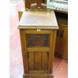 Oak bedside pot cabinet with carved detail