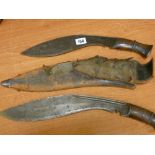 Two vintage kukri knives, one in a sheath