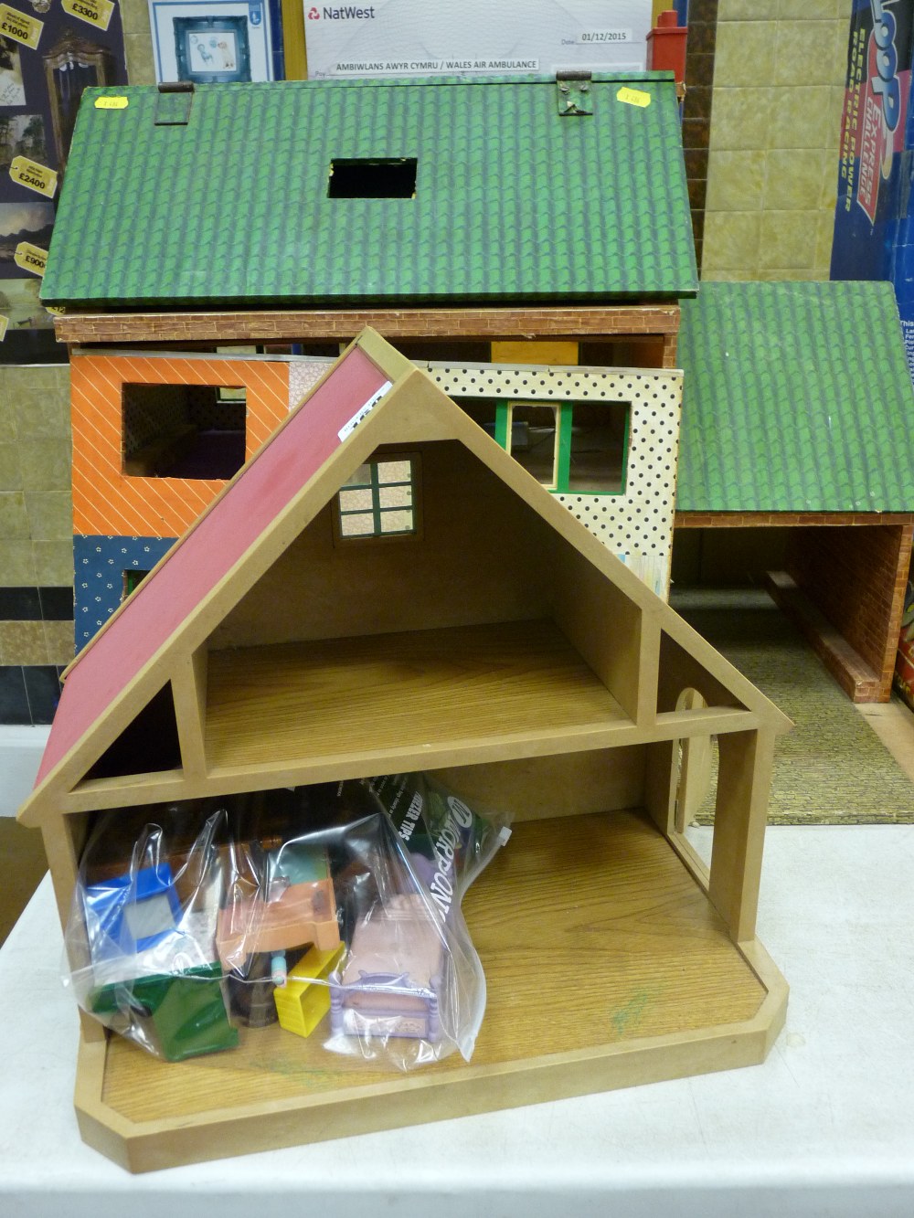 Vintage doll's house with accompanying building and an assortment of furniture