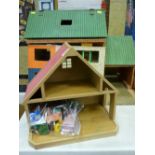 Vintage doll's house with accompanying building and an assortment of furniture