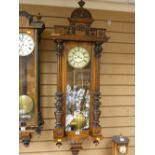 Good Vienna wall clock with carved sides, weights, pendulum and key included