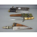 Three military daggers in sheaths including Indonesian, Sea Dayak etc