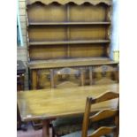 Oak refectory style dining table with four ladderback chairs, similar oak dresser with three shelves