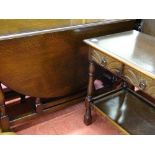 Mahogany drop leaf dining table and a two tier hall table with carved drawers and metal ring