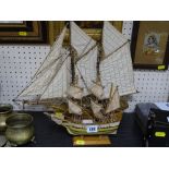 Two model sailing boats on stands