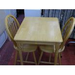 Modern light wood kitchen table and two spindleback chairs