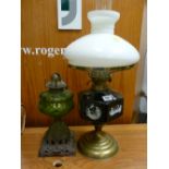 Brass based oil lamp with applied cameo reservoir and another iron based oil lamp