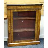 An antique inlaid and ebonized walnut single door pier cabinet, 76cms wide