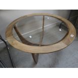 A circular glass topped G-Plan mid-century coffee table