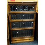 A good oak four-section leaded glass fronted Globe Wernicke bookcase with a drawer base, 146cms high