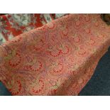 An antique red and green paisley patterned quilted throw / blanket, 203 x 173cms