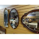 A vintage bevelled wall mirror of shaped form with moulded border to the frame together with an oval