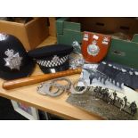 Quantity of assorted police related items to include truncheon, hats, handcuffs, pictures,